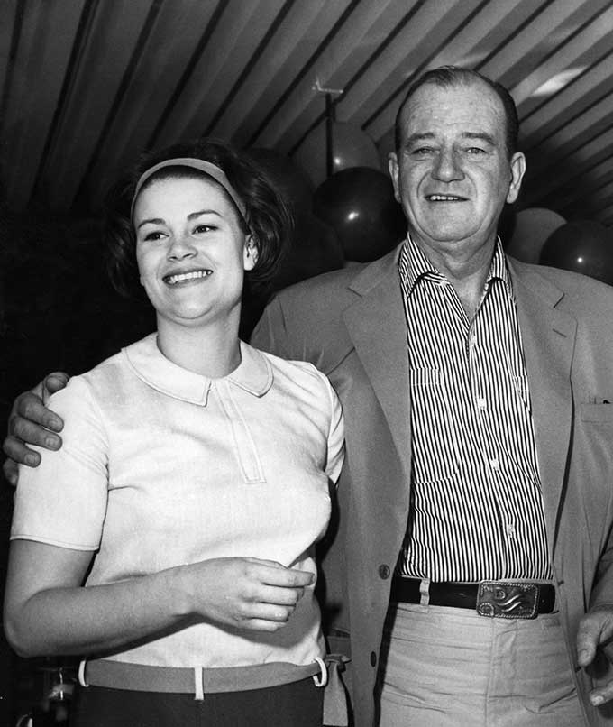 Melinda with her dad, who is wearing his signature Red River D belt buckle.