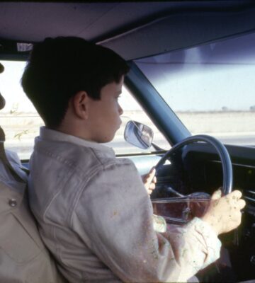 John Wayne and son in car