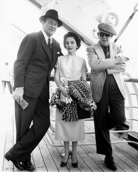 John Wayne, Pilar Wayne and John Ford traveling from New York to Southampton aboard the Liberté to see the first James Bond film Dr. No in 1963. Photo courtesy of John Wayne Enterprises