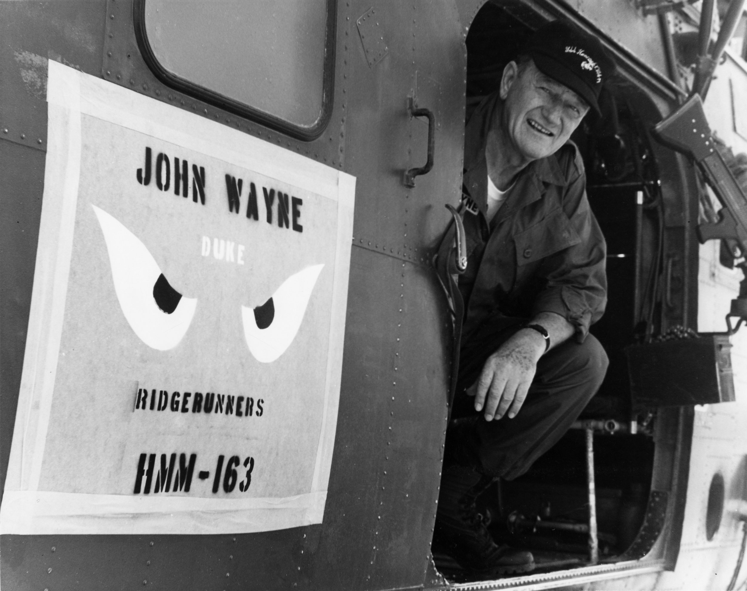 John Wayne aboard the Medium Lift Tiltrotor Squadron HMM-163 while visiting the troops in Vietnam in 1966. The aircraft was commandeered by the US Marine Corps helicopter squadron known as the “Ridge Runner’s”. The HMM-163 featured painted "Genie Ey…