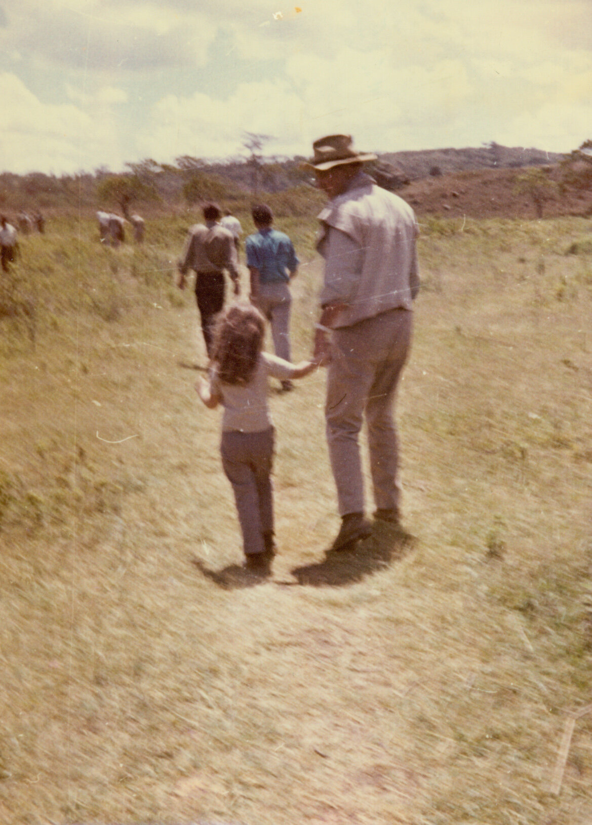 Aissa and her dad walk hand-in-hand in Africa.