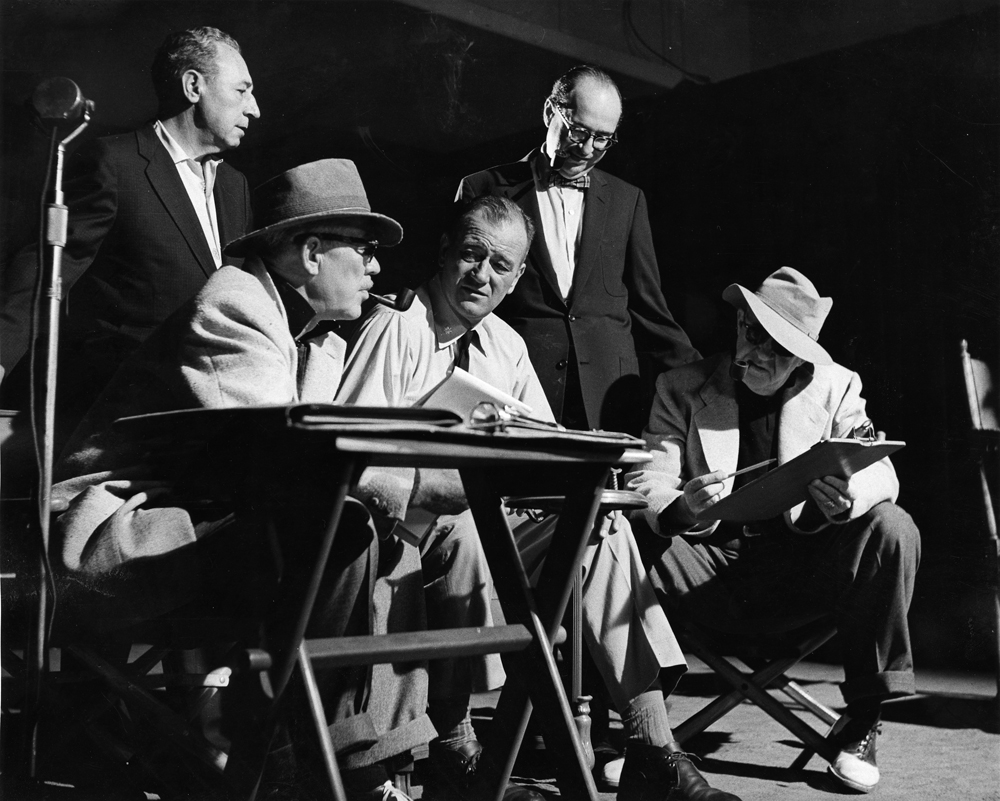 Seated from left- Ward Bond, John Wayne, and John Ford behind-the-scenes of The Wings of Eagles (1957), photo courtesy of MGM