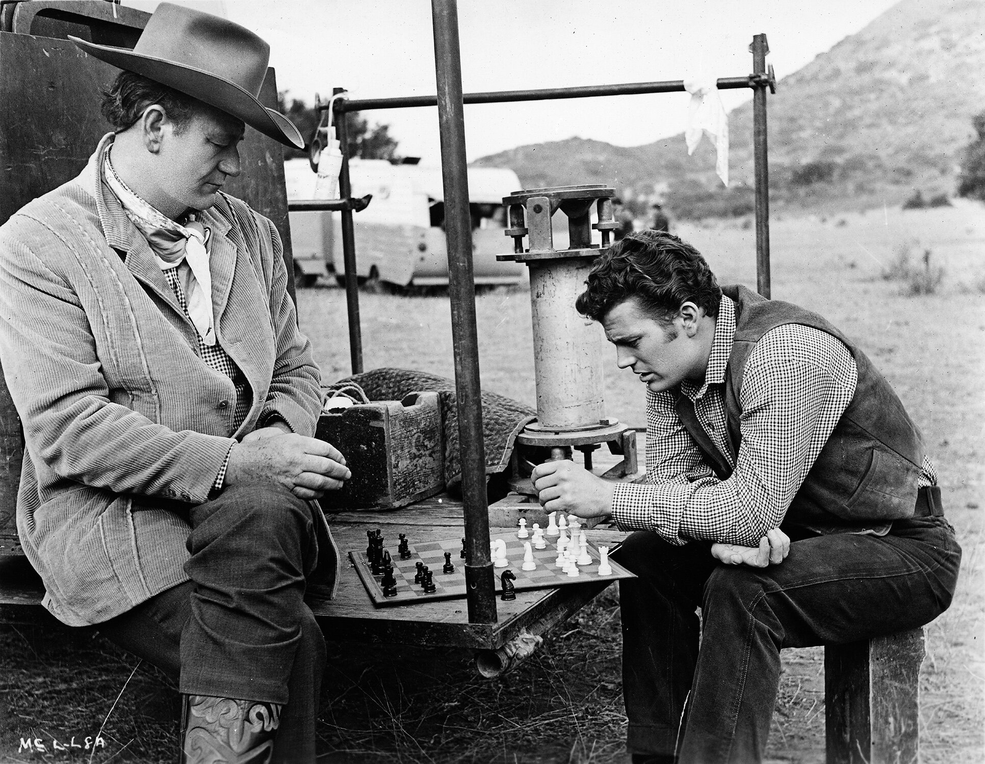 Known for playing a game or two during downtime, John Wayne and Patrick pick up a game of chess on set of McLintock!