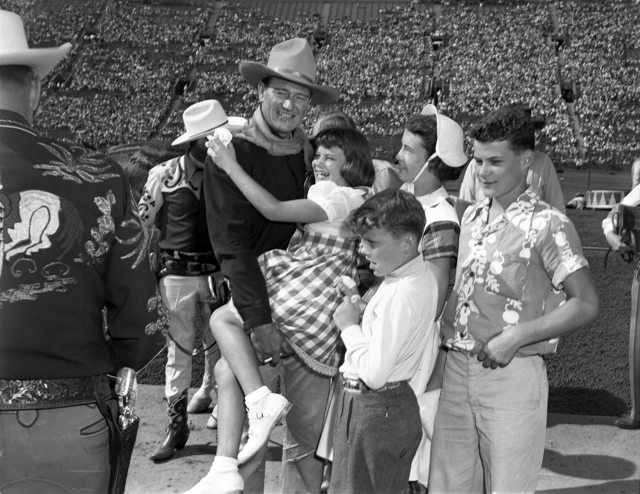 John Wayne with Melinda, Toni, Patrick and Michael (left to right) at a rodeo event.