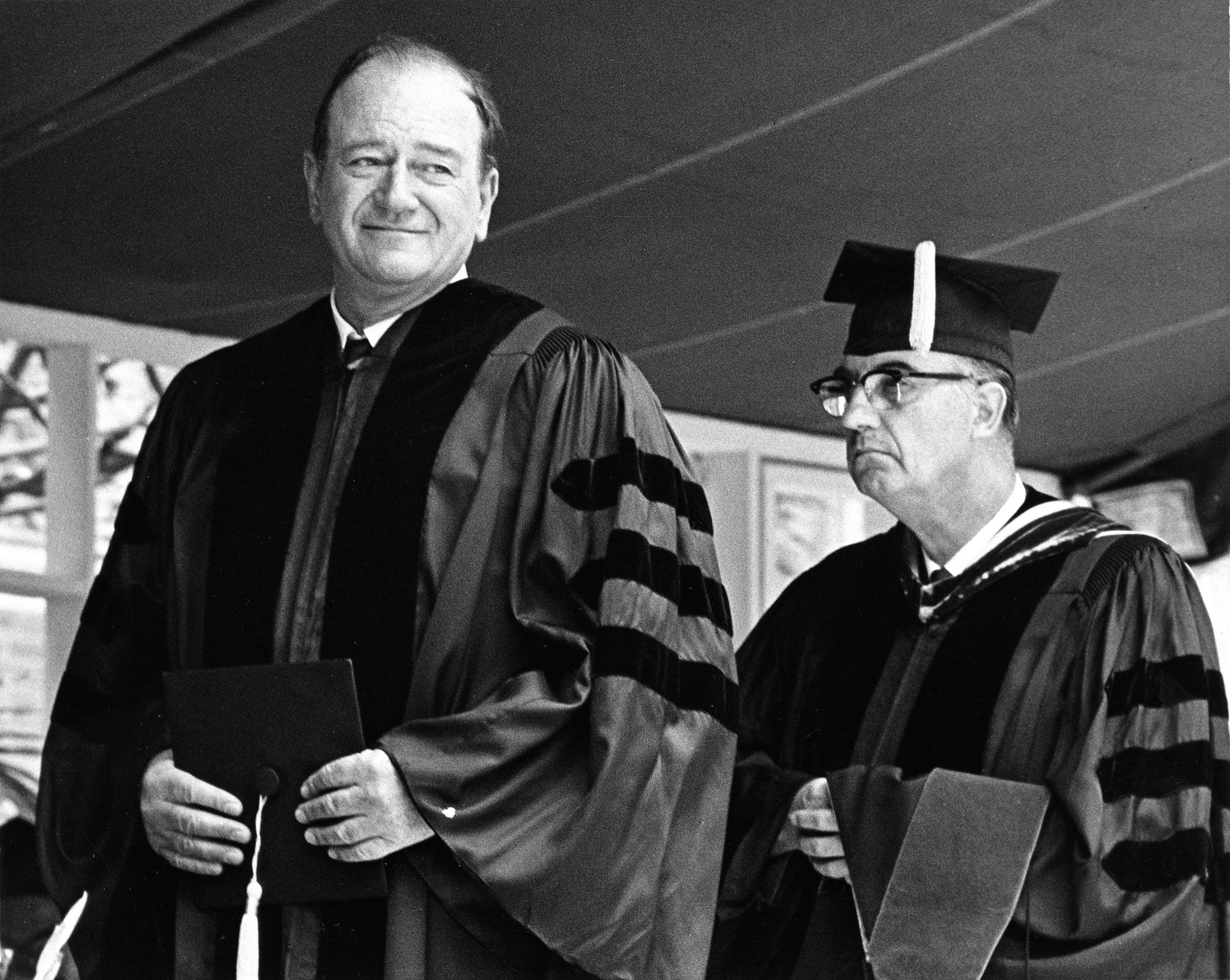 John Wayne (left) receiving his honorary doctorate degree from USC in 1968.