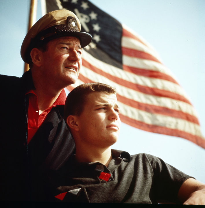 John Wayne and Patrick Wayne aboard Duke’s boat the Norwester in the 1950s. Image by John R. Hamilton, photo courtesy of John Wayne Enterprises
