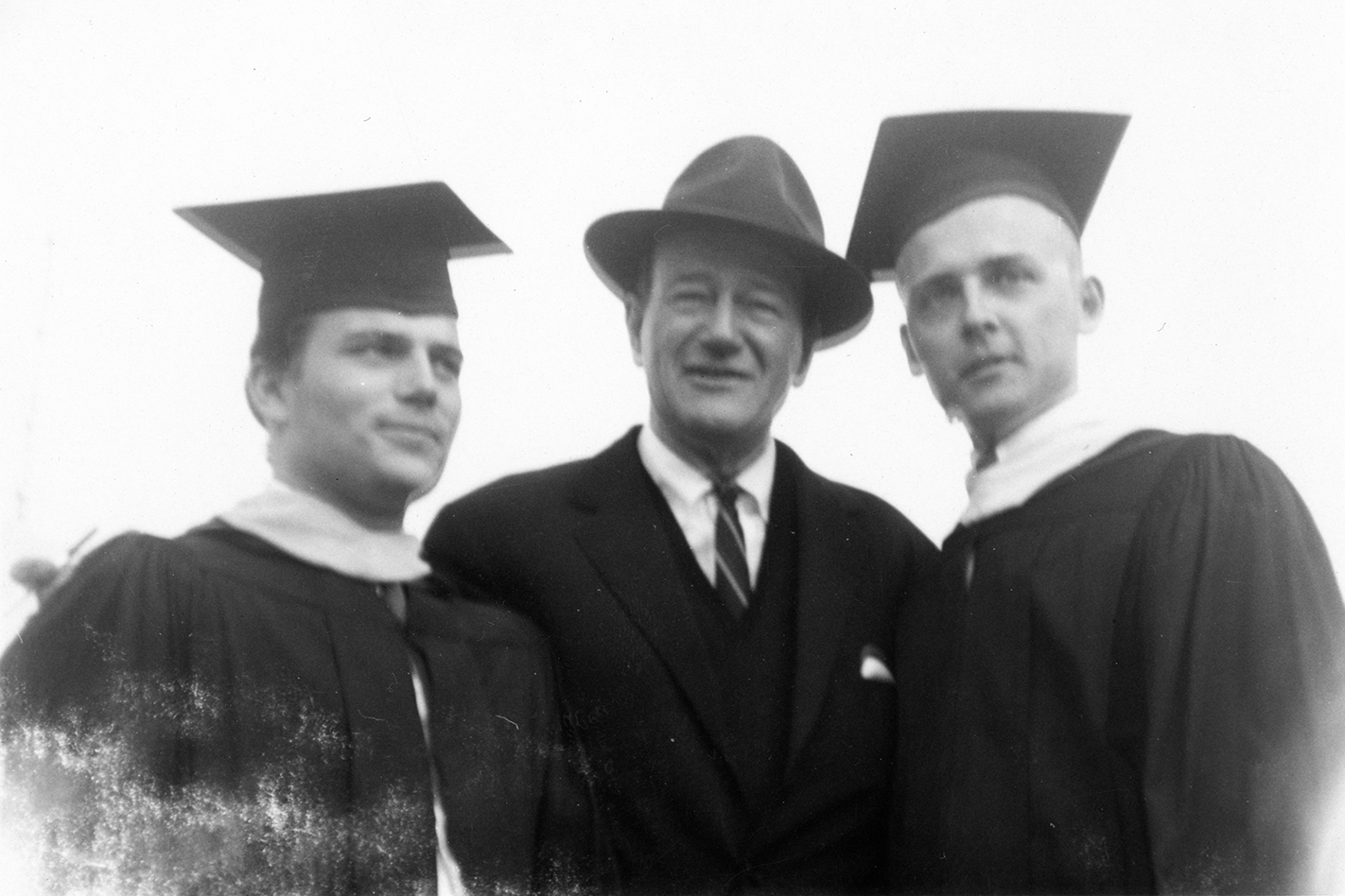 John Wayne (center) with son Patrick (left) at his graduation from LMU in 1961.