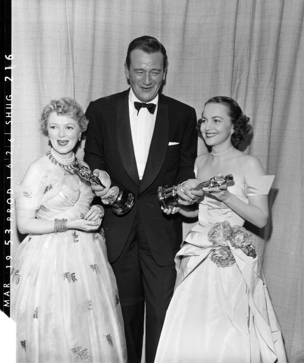 John Wayne holding Gary Cooper’s Oscar and John Ford’s Oscar at the 1953 Academy Award Ceremony. Photo courtesy of the Academy of Motion Picture Arts and Sciences