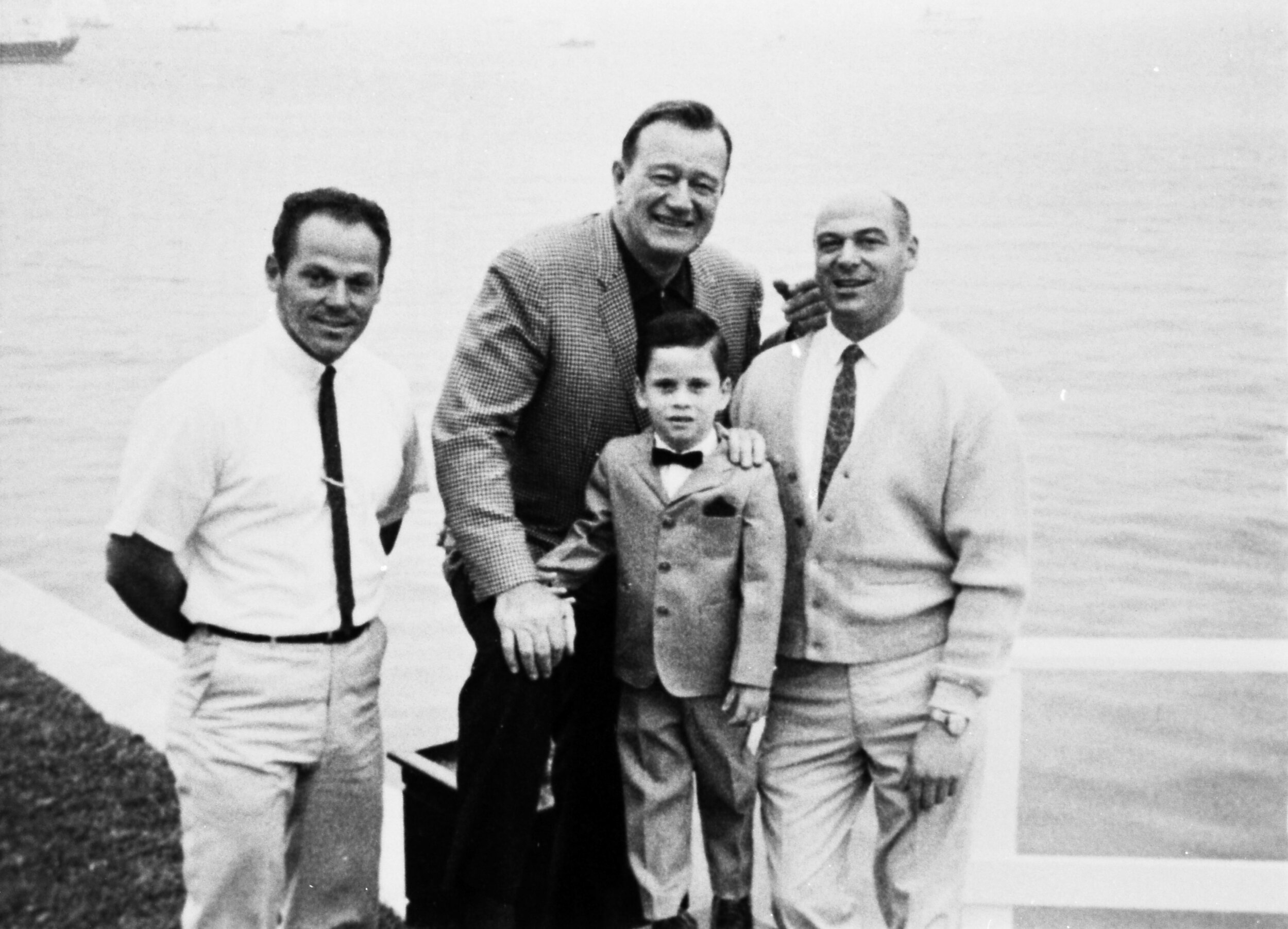 John Wayne, Ethan and Bert Minshall (left), captain of the Wild Goose.
