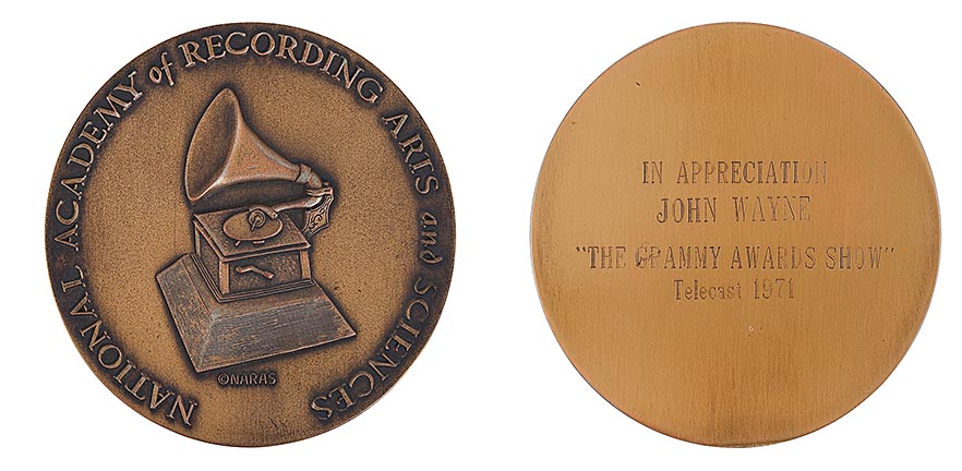 For the Left Image (Front of Medal)
"Bronze Grammy Awards commemorative medal featuring a detailed gramophone engraving and the text ‘National Academy of Recording Arts and Sciences.’"

For the Right Image (Back of Medal)
"Back of John Wayne’s Grammy Awards commemorative medal from 1971, engraved with ‘In Appreciation John Wayne – The Grammy Awards Show – Telecast 1971.’"