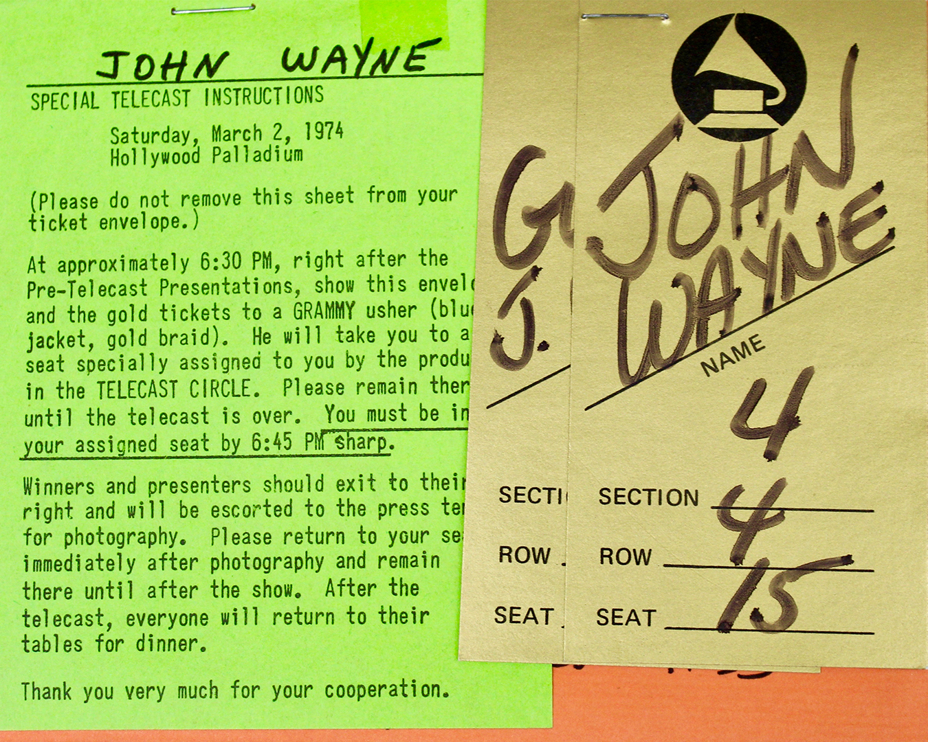 ohn Wayne’s 1974 Grammy Awards seating tickets and telecast instructions on green and gold paper, detailing arrival times, assigned seating, and backstage access for the event at the Hollywood Palladium.