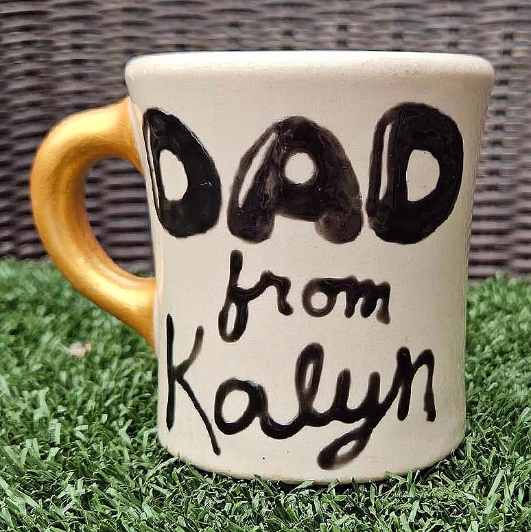 Michael Speck’s most cherished mug—a personalized gold-handle gift from his daughter.